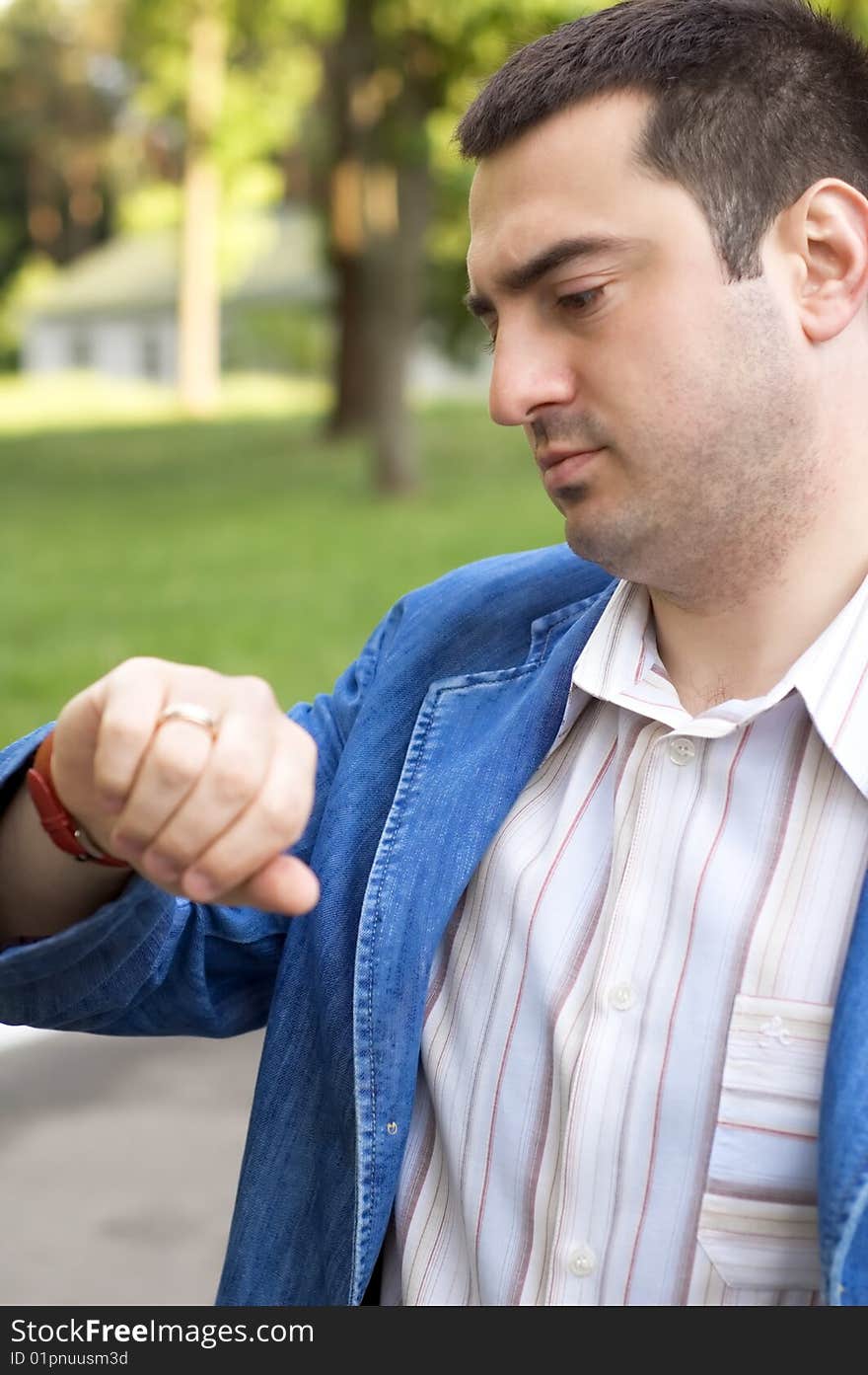 The Young Man Looks At The Watch.