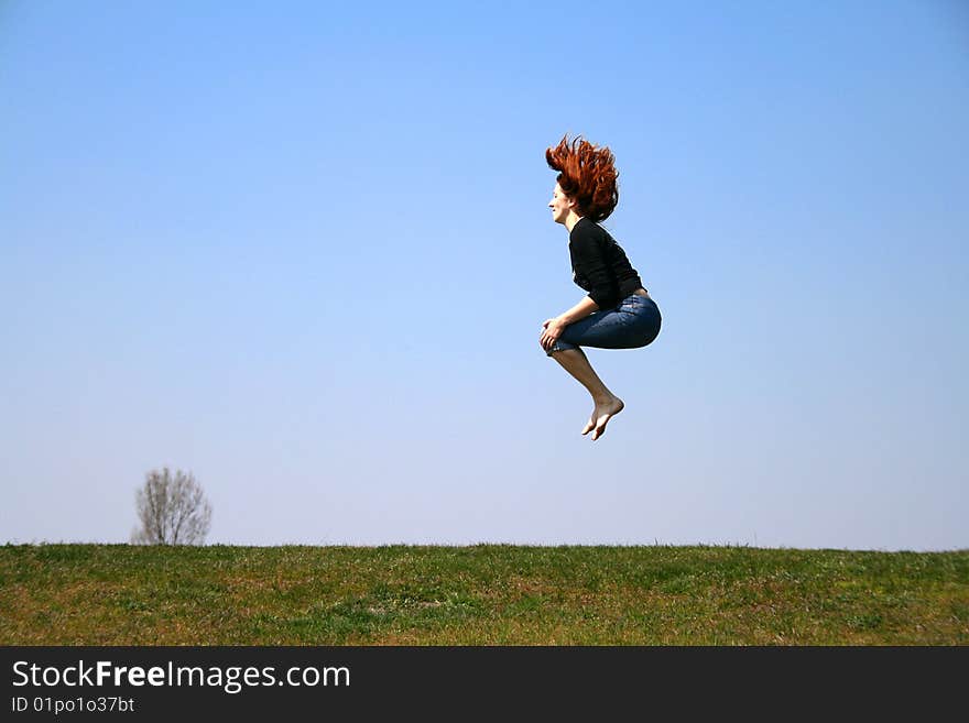 The girl taken in a jump like sitting in the air. The girl taken in a jump like sitting in the air