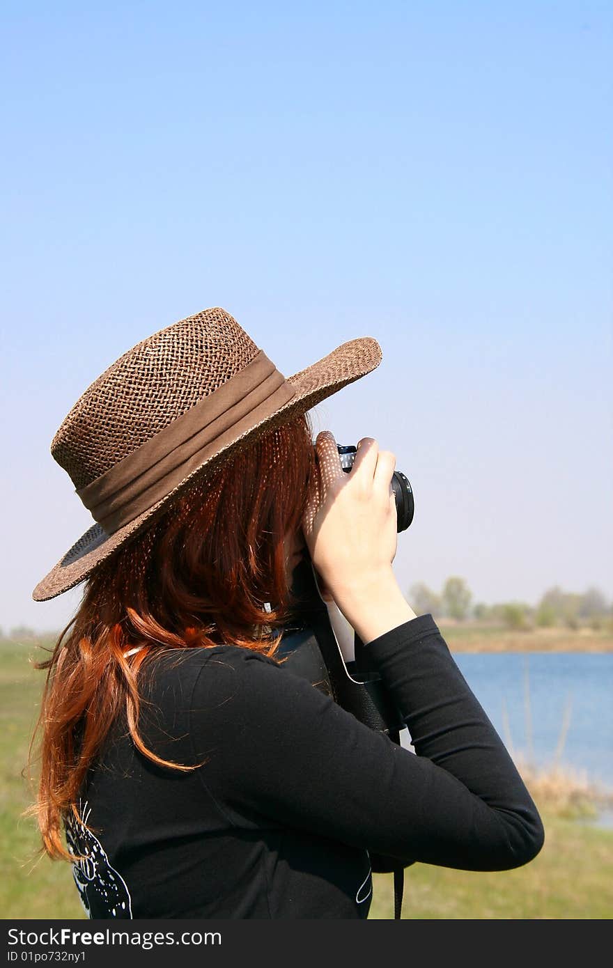 The girl in the hat with the camera