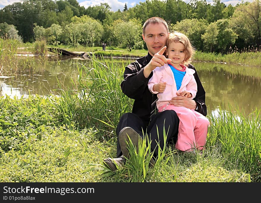 Little girl with a dad on a lake. Little girl with a dad on a lake.