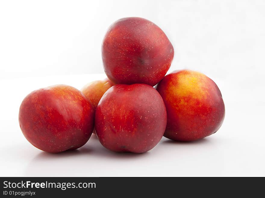 Red and yellow peaches isolated over white background