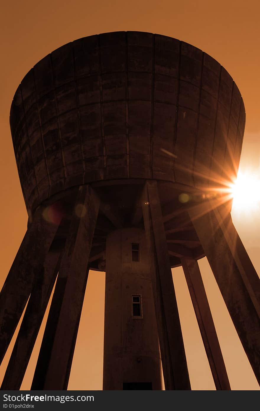 A water tower in the irish countryside on a hot day with a white background in sepia. A water tower in the irish countryside on a hot day with a white background in sepia