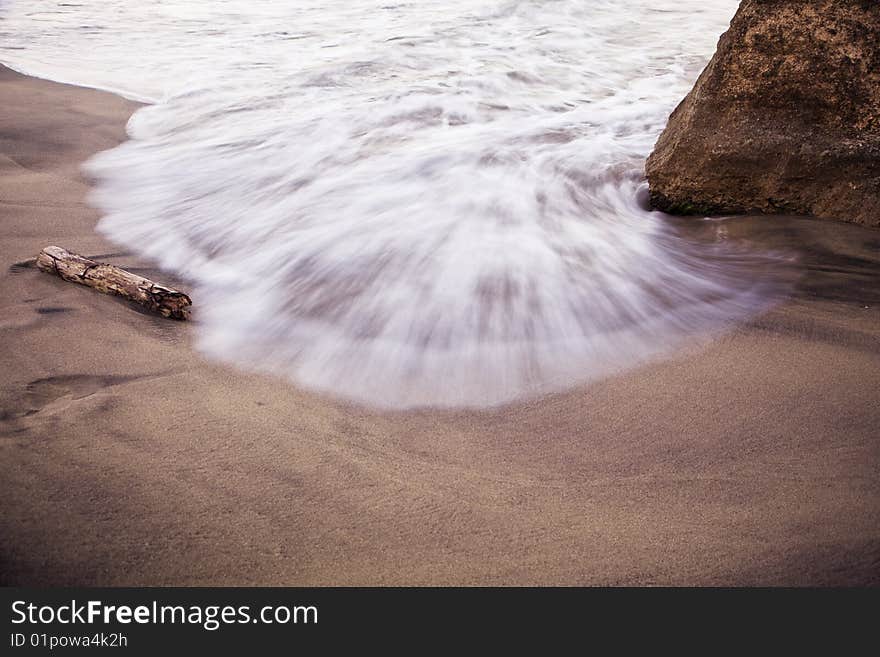 Long exposed water fighting with rock.