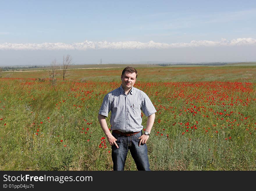 The tourist poses on steppe background in Kazakhstan. The tourist poses on steppe background in Kazakhstan