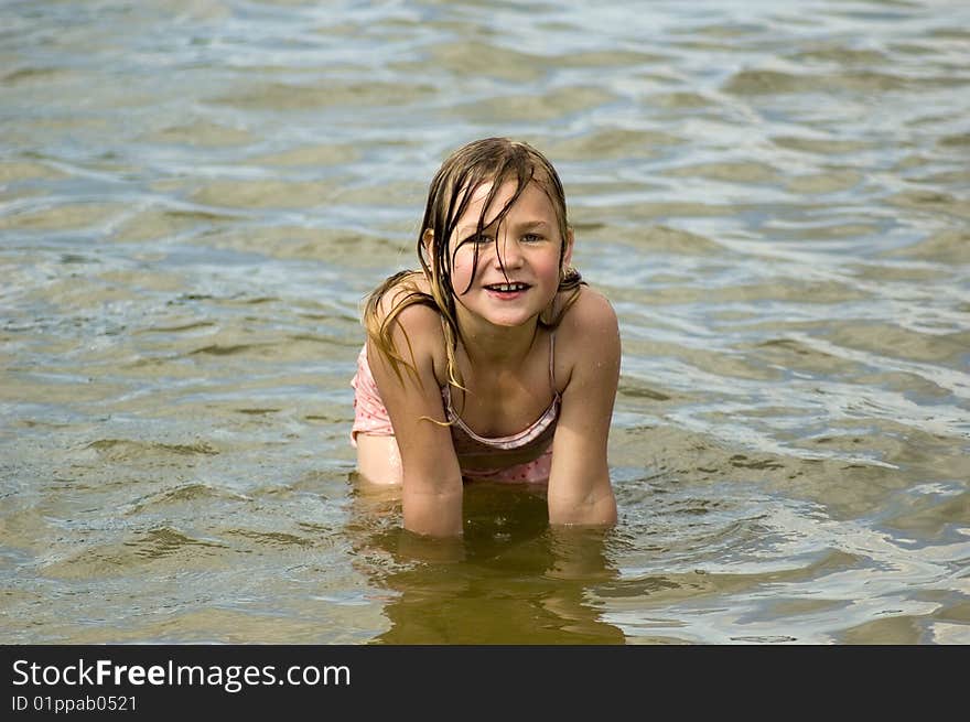 Little Girl Is Playing In The Water