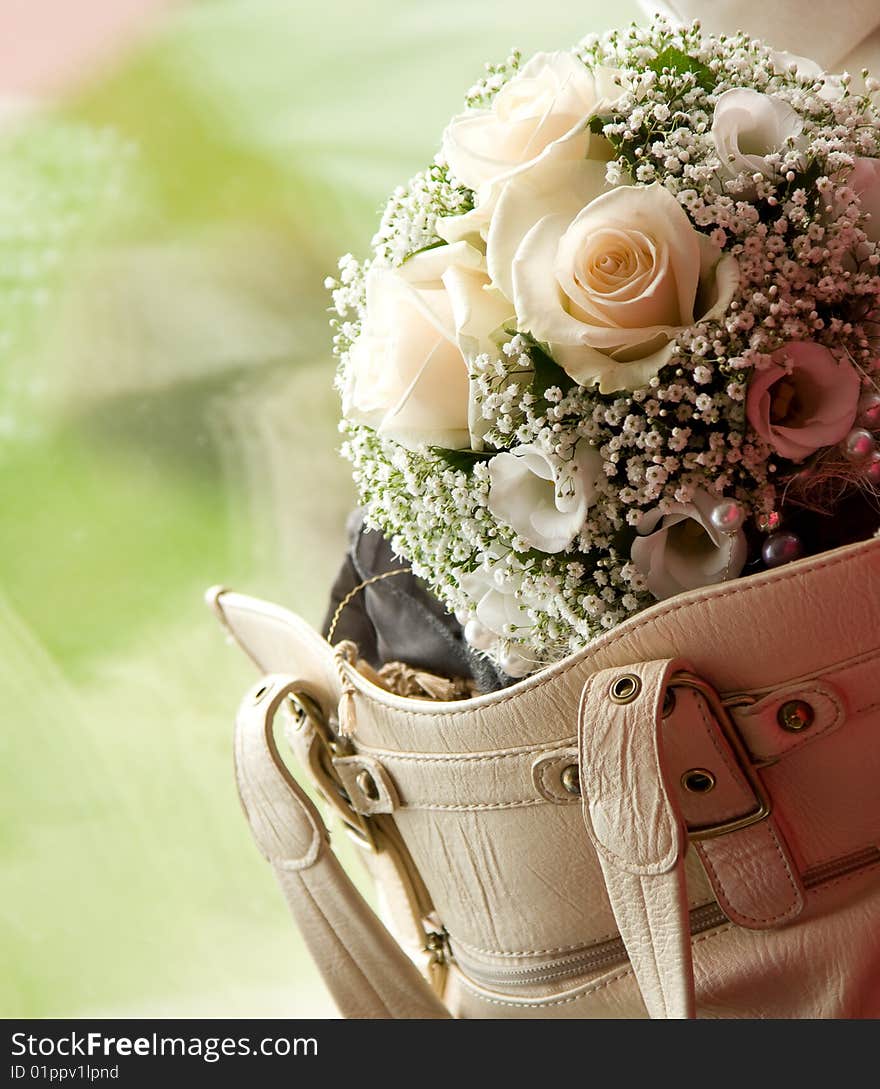 Wedding bouquet in woman bag with outdoor on the background. Wedding bouquet in woman bag with outdoor on the background