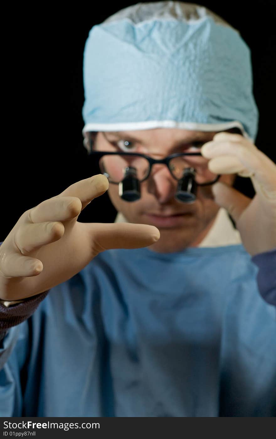 Surgeon reaches hand towards patient for examination. Surgeon reaches hand towards patient for examination.