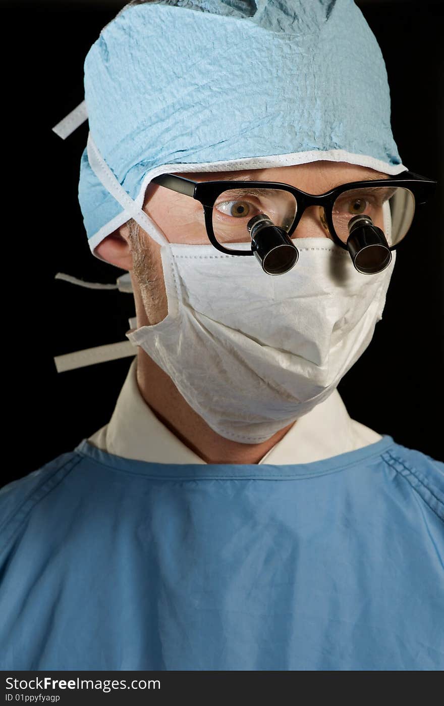 Doctor in scrubs prepared for close examination. Doctor in scrubs prepared for close examination