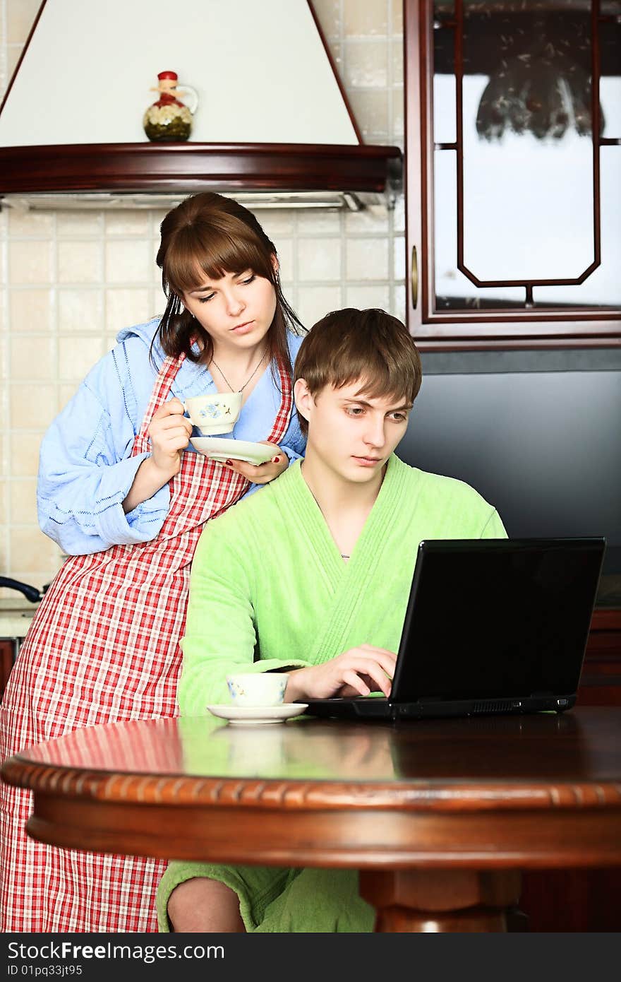 Happy young couple on a kitchen at home. Happy young couple on a kitchen at home.