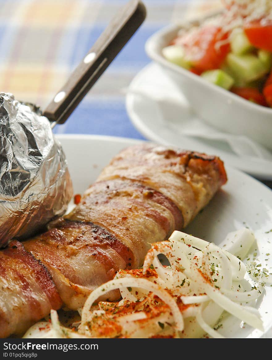 Grilled meat served with potato and salad. Grilled meat served with potato and salad