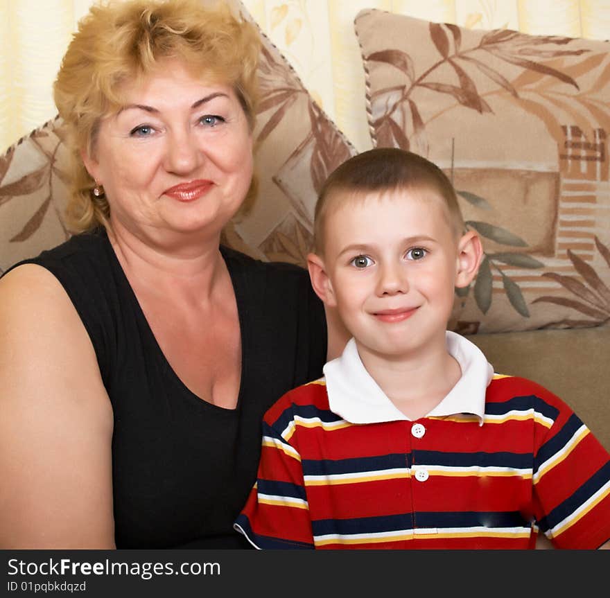 Young grandmother with grandchildren at home on the couch. Young grandmother with grandchildren at home on the couch