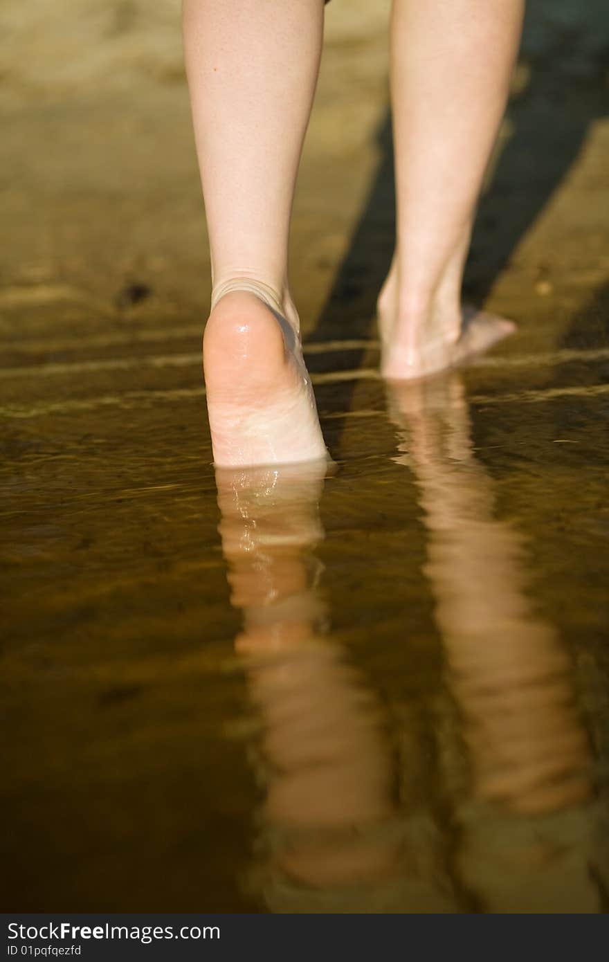 Barefoot legs in river