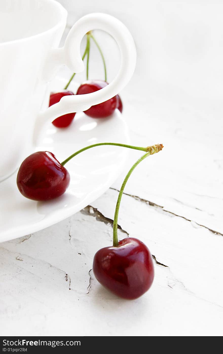 Some cherries in cup over grunge background