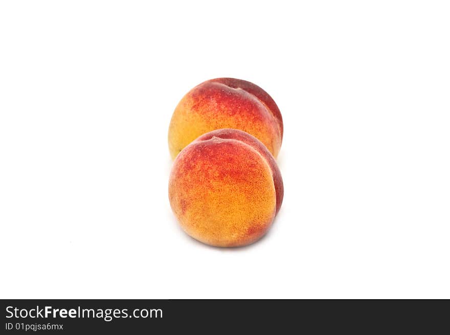 Two isolated peaches