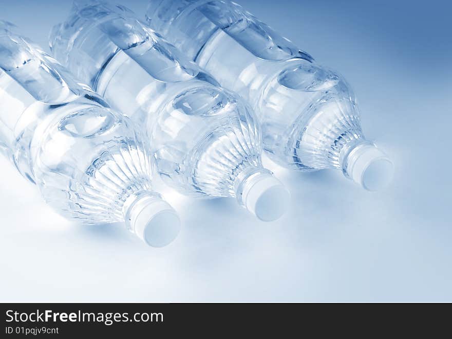 Bottled water over a white-blue background. Bottled water over a white-blue background