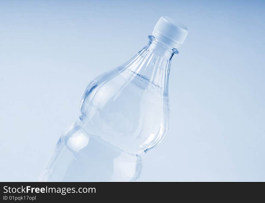 Bottled water over a white-blue background. Bottled water over a white-blue background