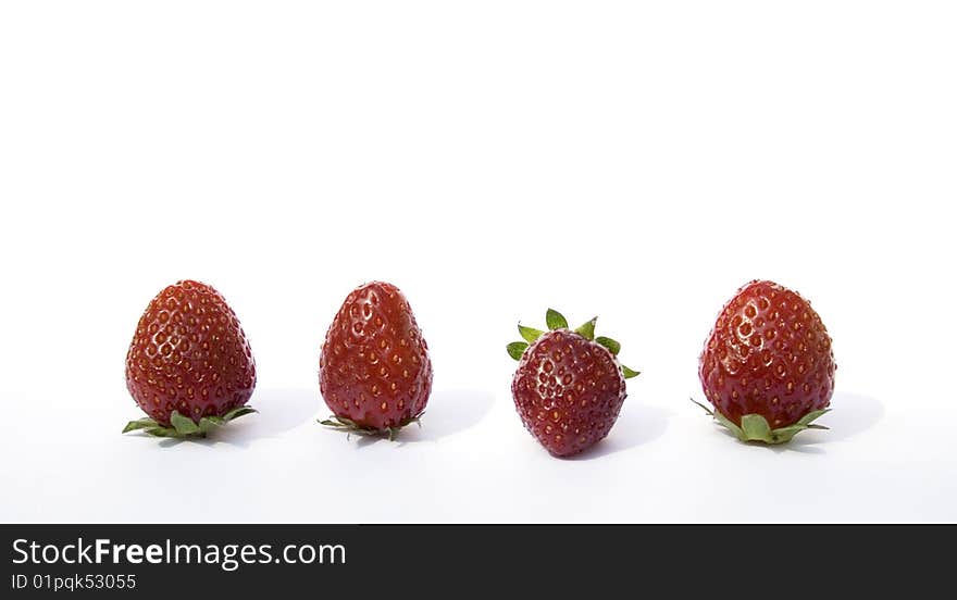 Four fresh strawberries on a white background. Four fresh strawberries on a white background