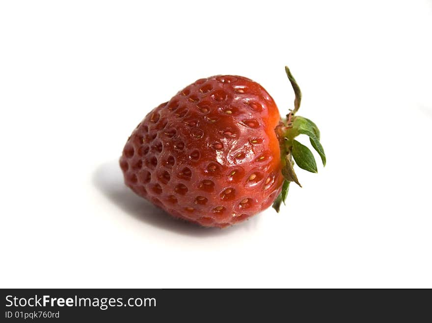 One isolated strawberry on a white background. One isolated strawberry on a white background