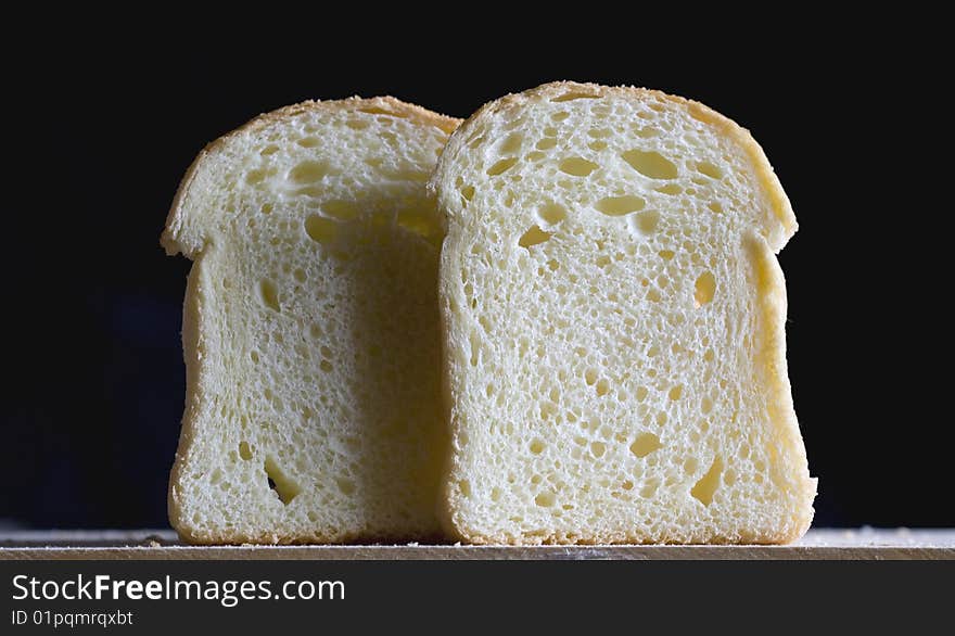 Close up of two bread slices on a black background