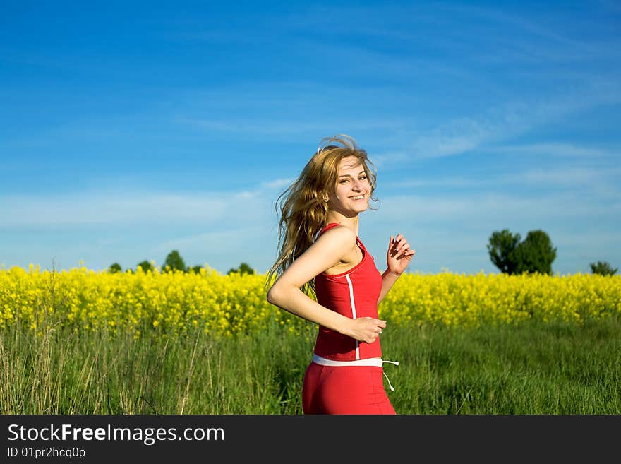 An image of a beautiful girl running in the field. An image of a beautiful girl running in the field