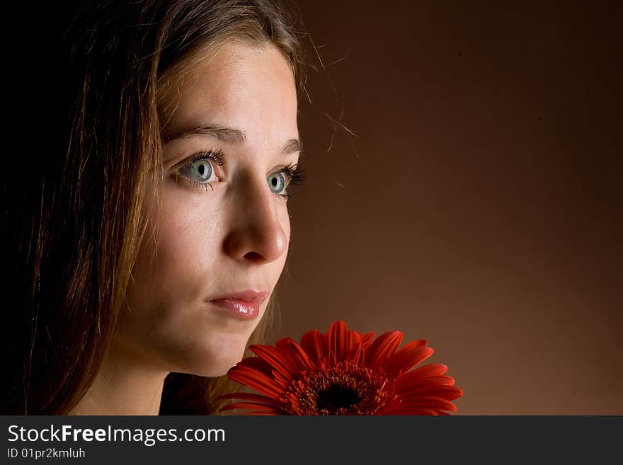 Young woman with a red flower