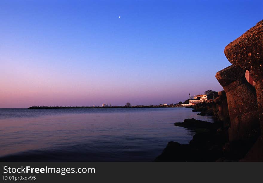 Black sea in sunrise and blue, colored sky