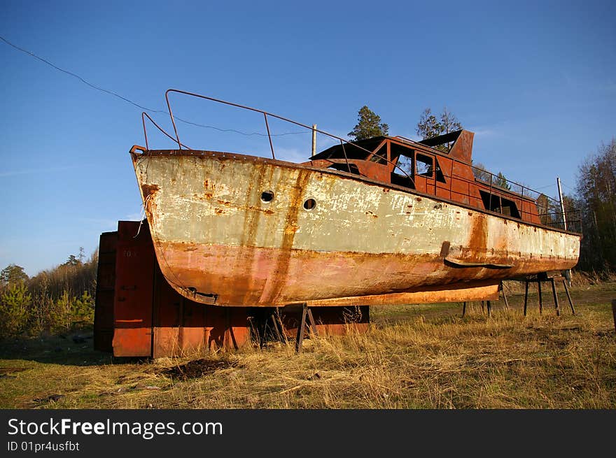 An old broken rusty boat. An old broken rusty boat