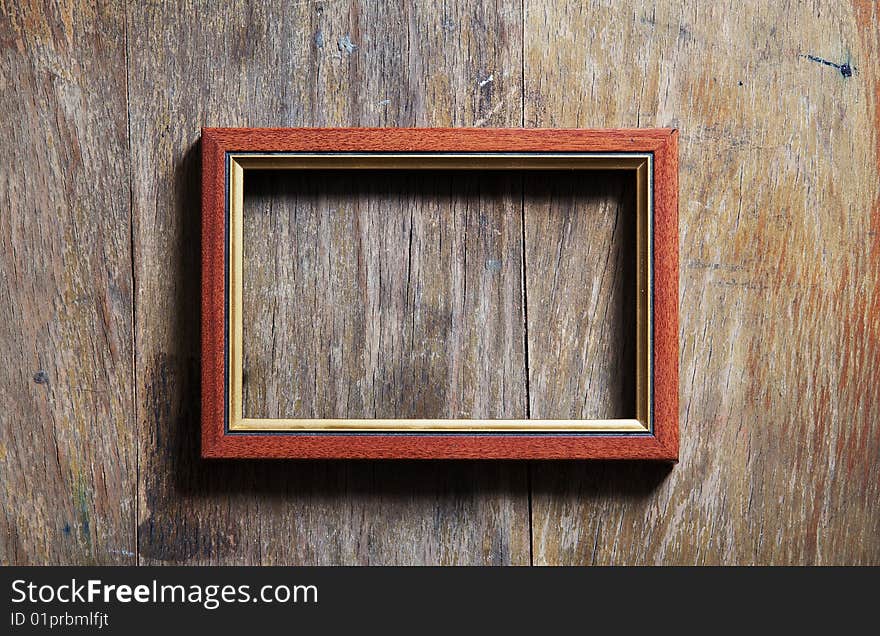 Empty frame on wooden background