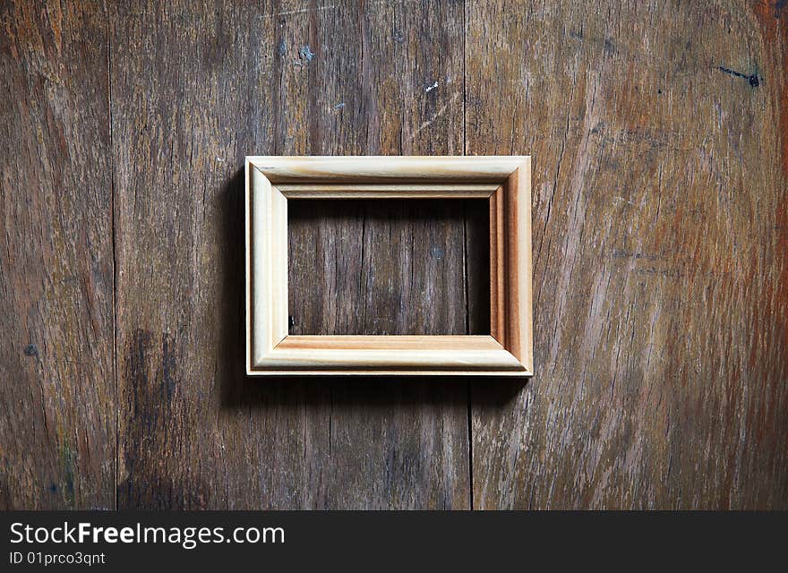 Empty frame on wooden background