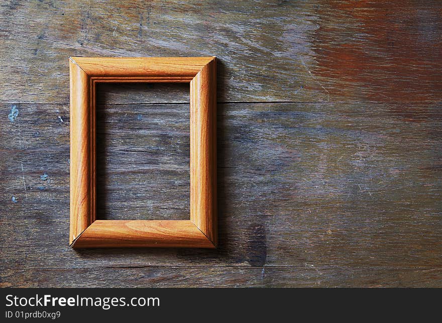 Empty photo-frame on wooden background. Empty photo-frame on wooden background