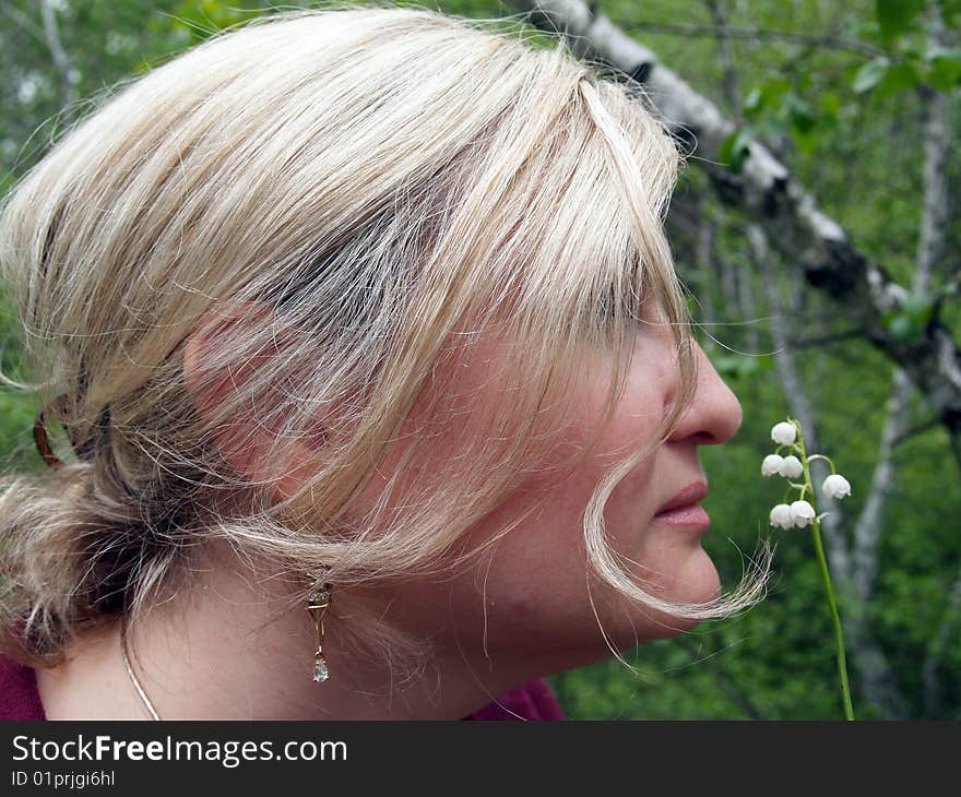 Woman in spring forest, enjoys flowers. Woman in spring forest, enjoys flowers