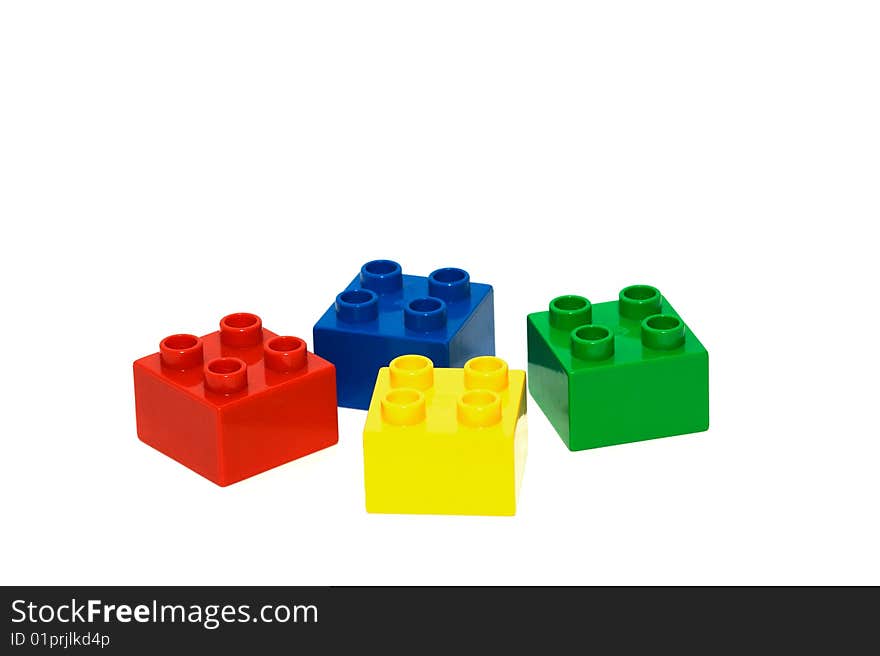 A collection of brightly coloured building bricks isolated on a white background. A collection of brightly coloured building bricks isolated on a white background