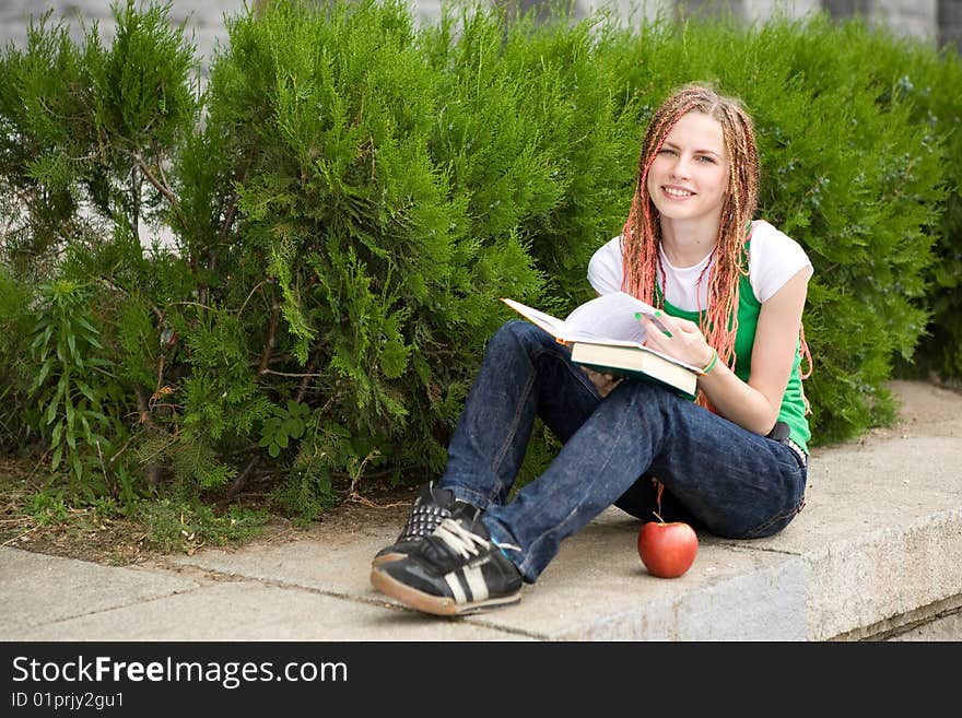 Girl with a book near the school. Girl with a book near the school