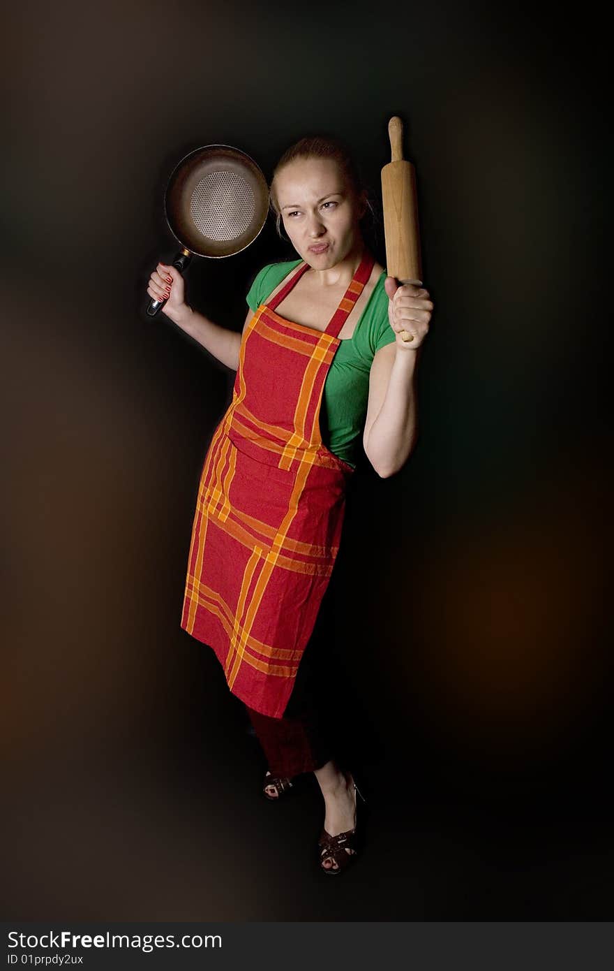 Woman with kitchen tools - as angry wife