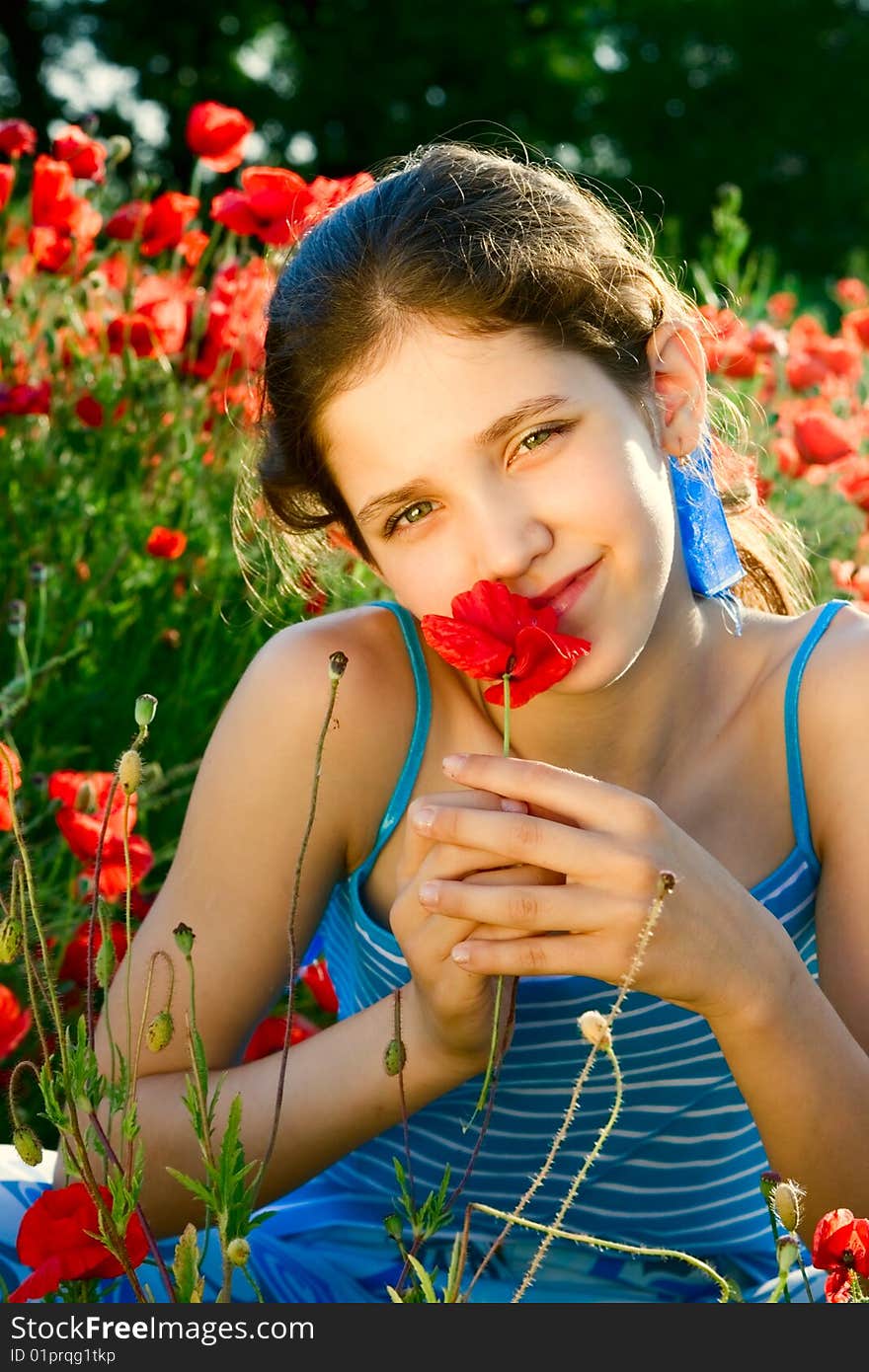 Portrait teen girl with poppy on nature