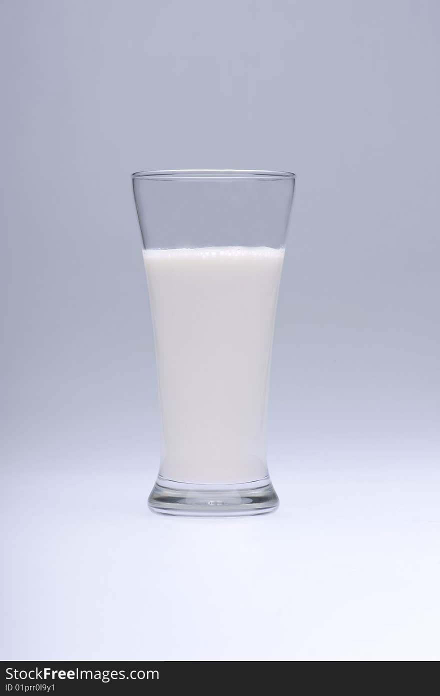 Glass of milk on white background