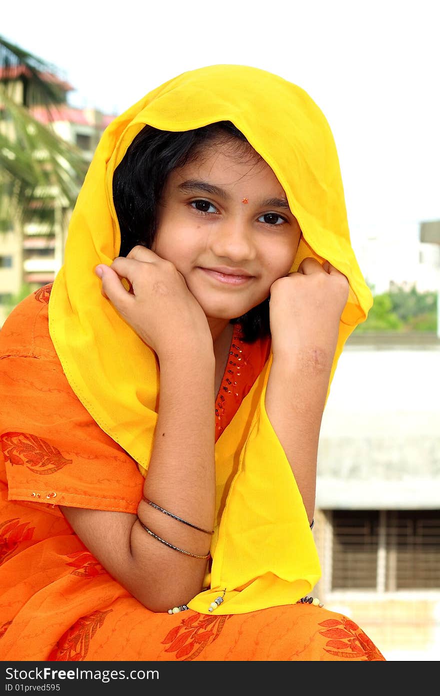 A beautiful Indian girl happily smiling in a soft and nice mood. A beautiful Indian girl happily smiling in a soft and nice mood.