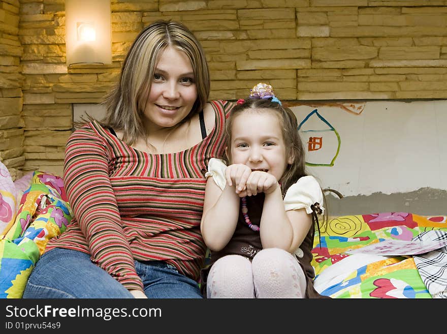 Cute girl sitting with beautiful mother