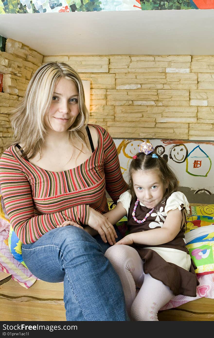 Cute Girl Sitting With Beautiful Mother. Cute Girl Sitting With Beautiful Mother