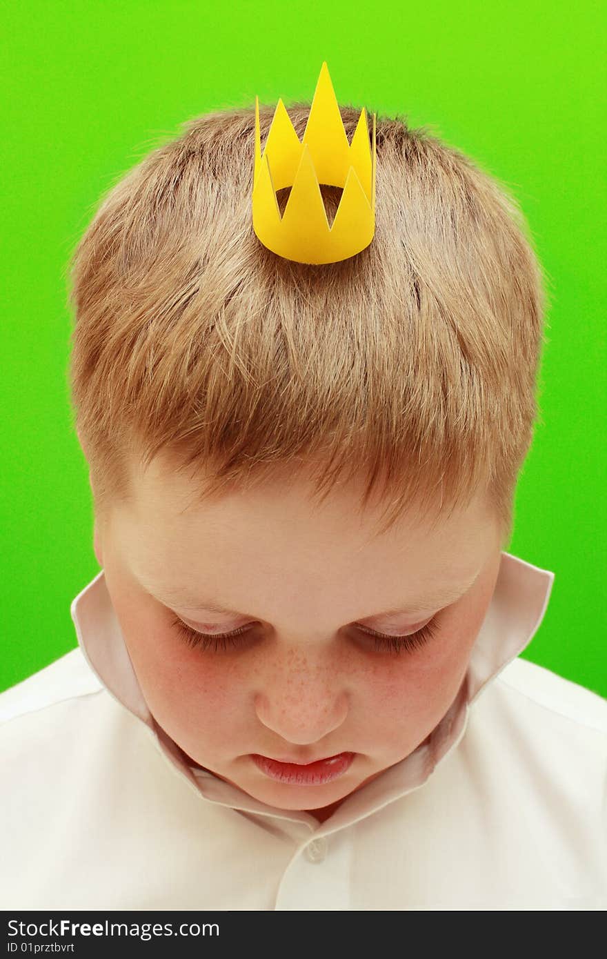 Boy with a crown on a green background