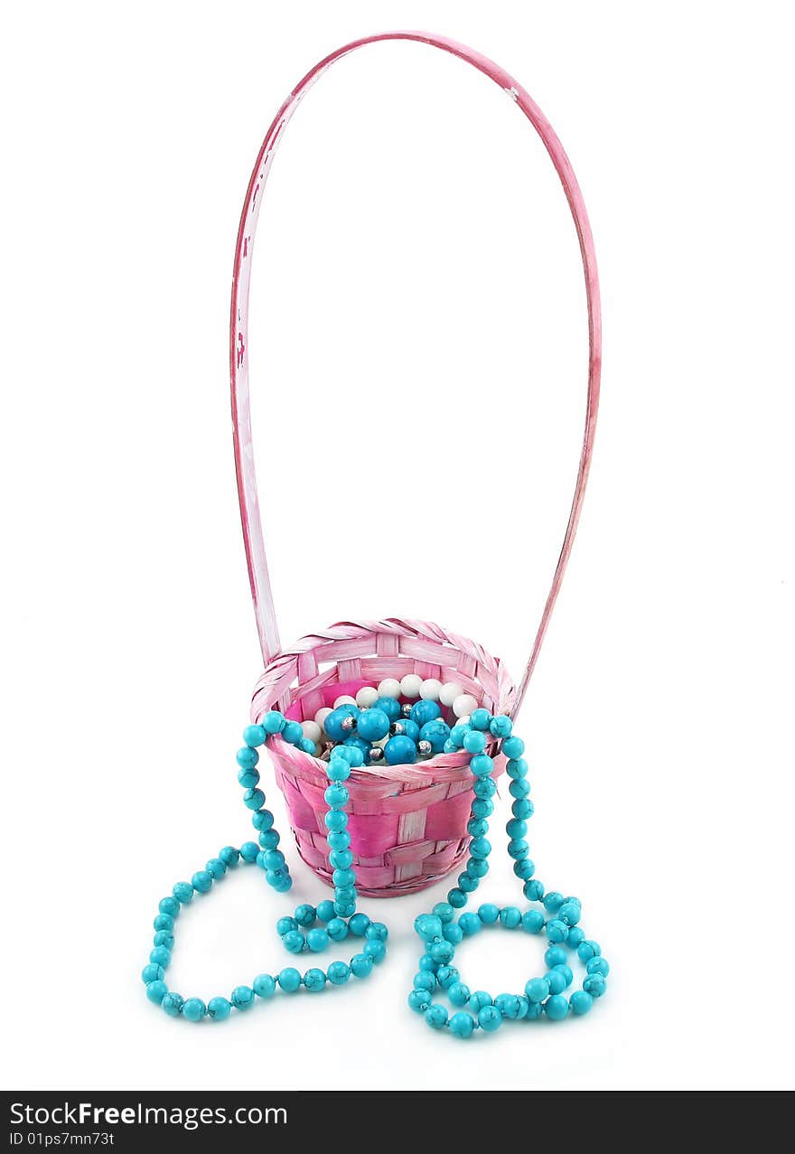 Colored Pearl Beads in Pink Wicker Basket Isolated