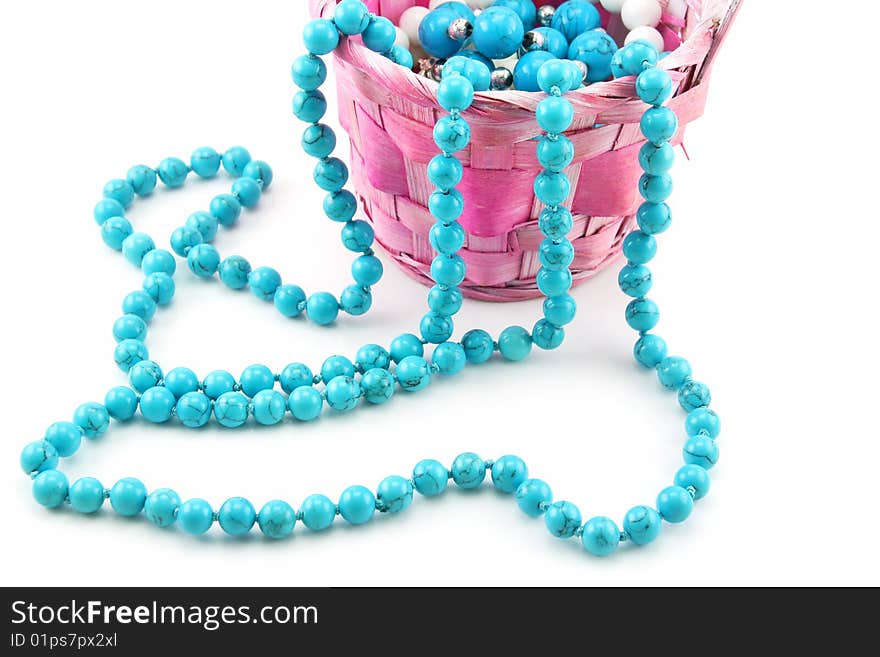 Colored Pearl Beads In Pink Wicker Basket Isolated