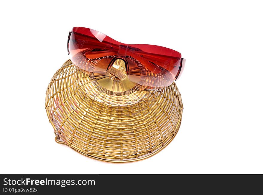 Sunglasses on inverted basket isolated on white background.