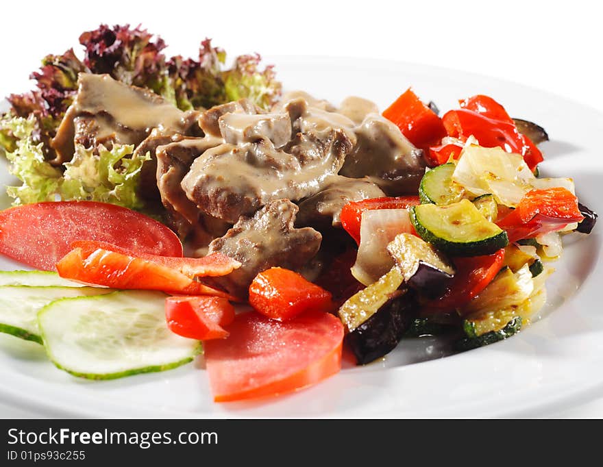 Stewed Beef with Vegetables and Fresh Vegetable on Plate. Stewed Beef with Vegetables and Fresh Vegetable on Plate