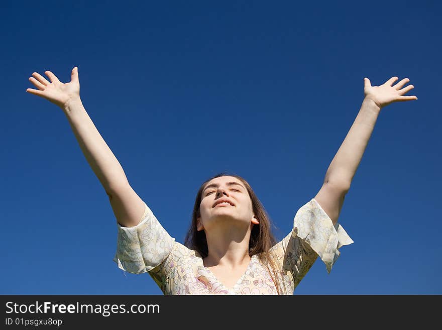 Woman is reaching to blue sky. Woman is reaching to blue sky