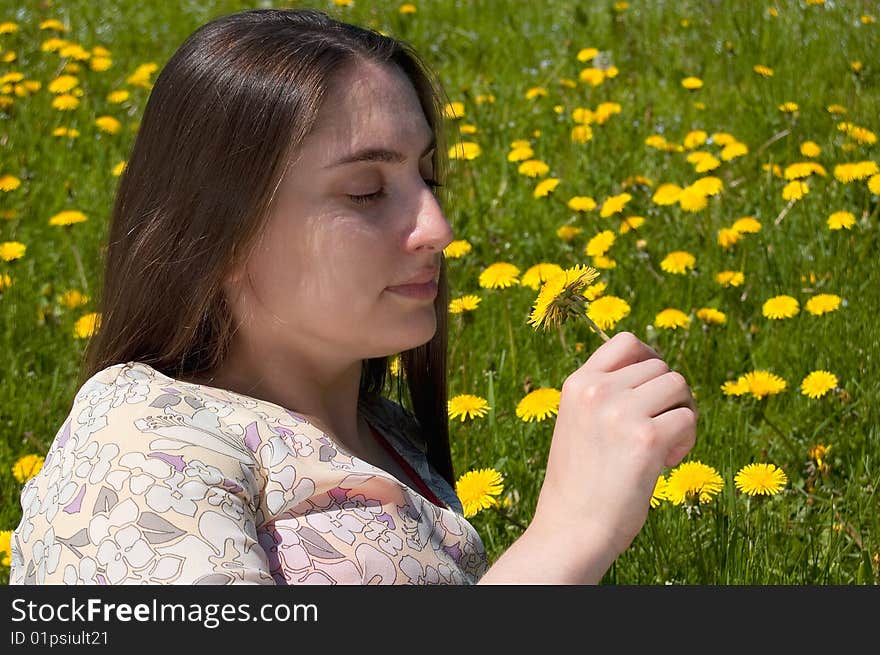 Young woman on colour meadow with dandelion. Young woman on colour meadow with dandelion