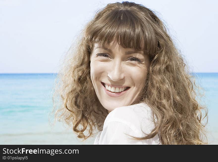 Portrait of nice young woman having good time on the beach. Portrait of nice young woman having good time on the beach