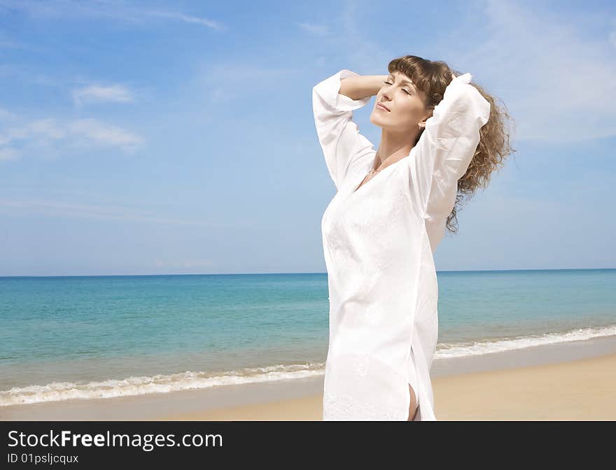 Portrait of nice young woman having good time on the beach. Portrait of nice young woman having good time on the beach