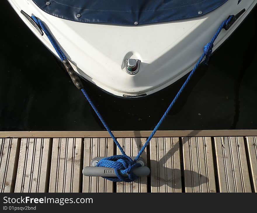 Close up of marine knot with blue rope, boat