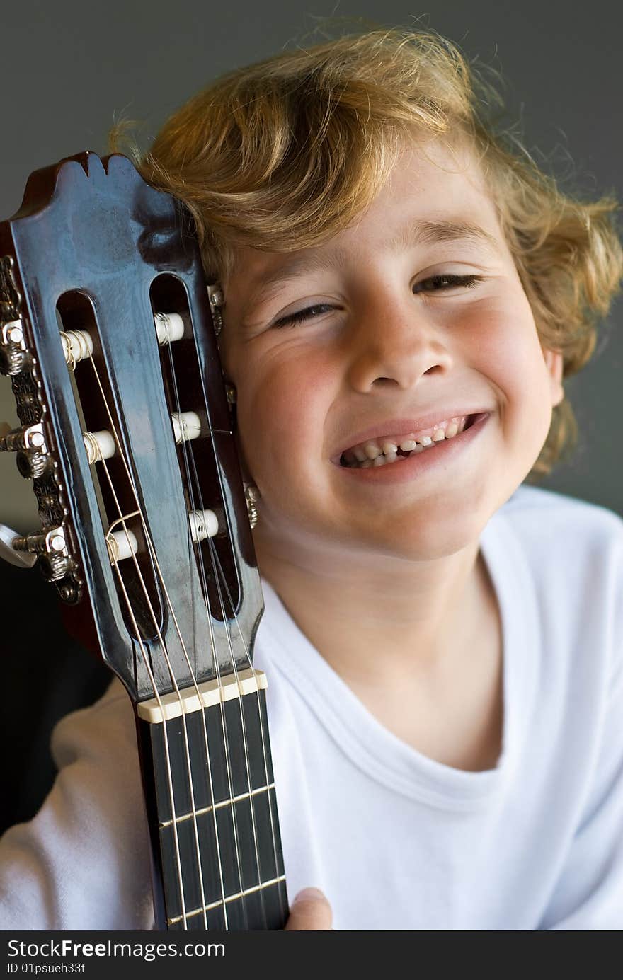 Young cute boy with guitar